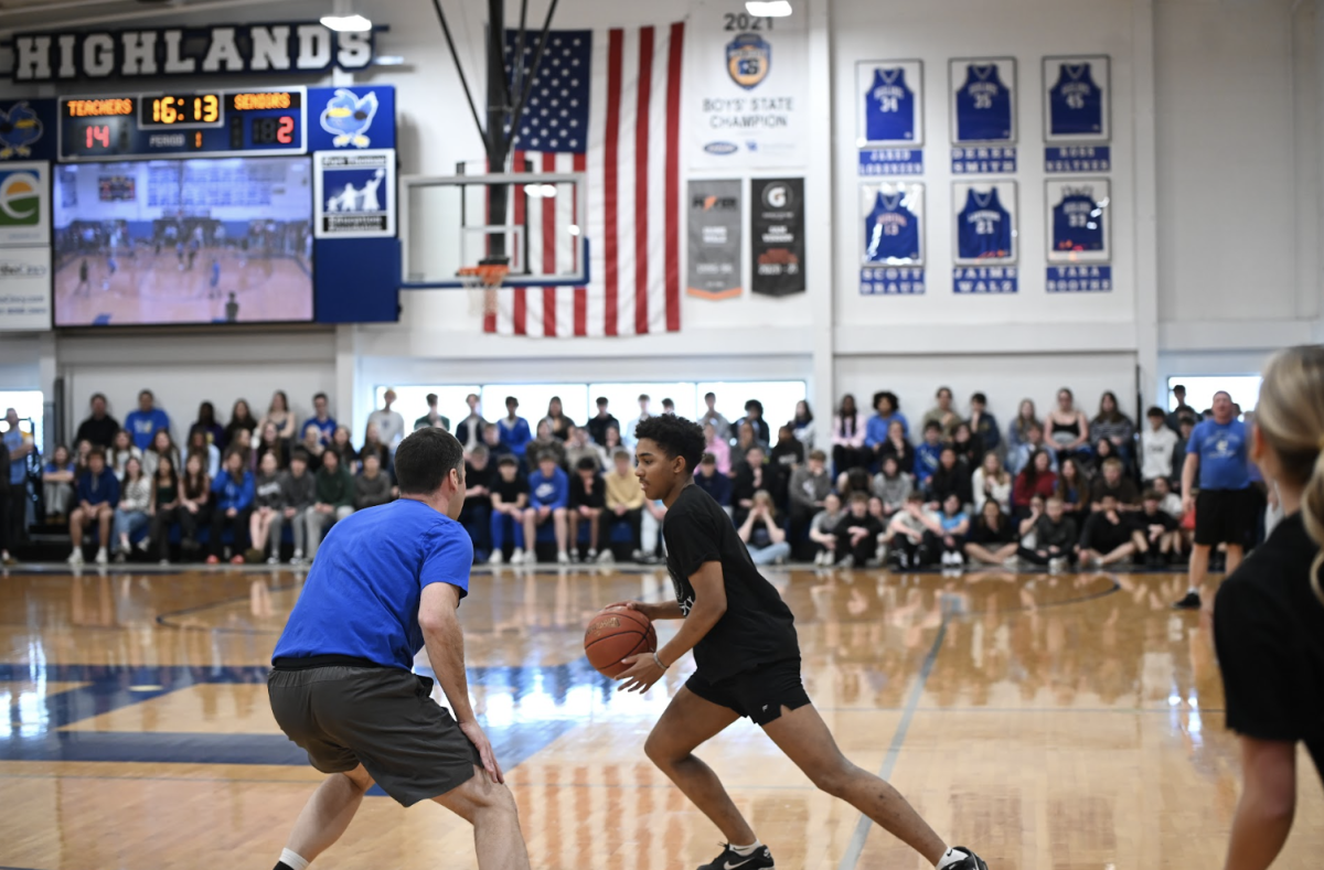 Iain Carner (12) dribbles the ball. " It was a great time being able to compete in a fun way and it was also a great way to share a moment with the teachers," Carner said. 